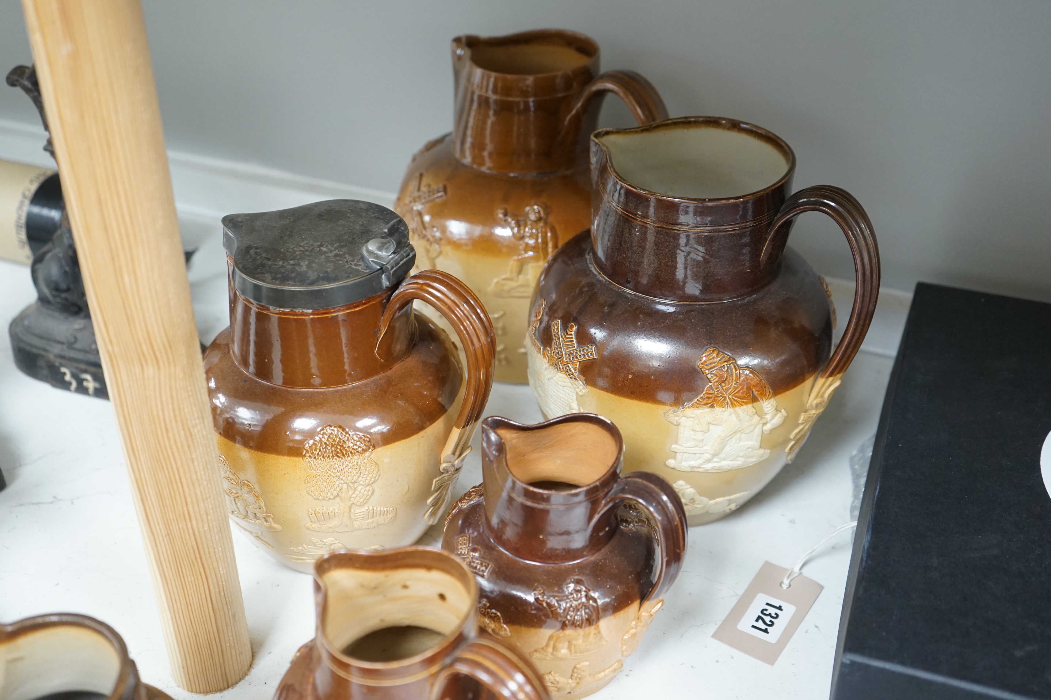 A group of eight Fulham & Lambeth salt-glazed stoneware jugs, tallest 22cm